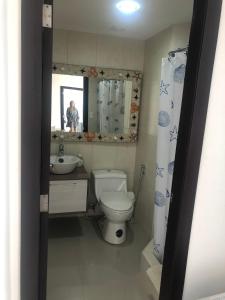 a bathroom with a toilet and a sink and a mirror at Punta Centinela in Punta Blanca +17 photos