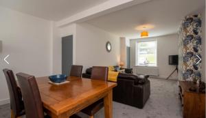 a living room with a wooden table and a couch at Nelson 2 Double bedrooms 1 bathroom in Crook