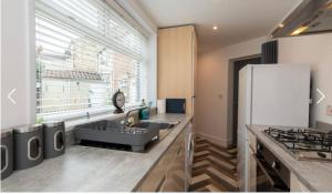 a kitchen with a sink and a refrigerator at Nelson 2 Double bedrooms 1 bathroom in Crook