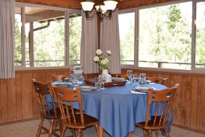 a dining room with a blue table and chairs at Sequoia House at The Redwoods in Wawona