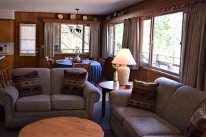 a living room with two couches and a table at Sequoia House at The Redwoods in Wawona +8 photos