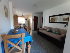 a living room with a blue table and a couch at Depto España Mdq in Mar del Plata