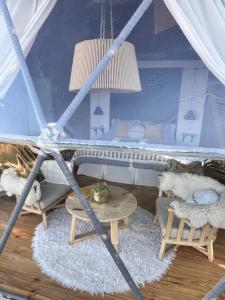 a room with a bed and a table and chairs at Bóreas Ecoluxury Glamping in El Calafate