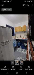een blik op een keuken met een koelkast bij Apartamento completo Jacumã in Conde