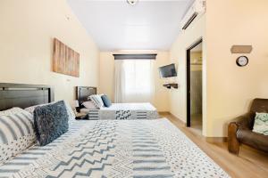 a living room with two beds and a couch at Villa Jr 3 near the peñon guacalillo in Tarcoles +26 photos