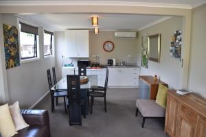 a kitchen and living room with a table and chairs at 73 Milton Accommodation in Cambridge