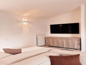 a living room with a bed and a flat screen tv at Villa in Apulia with pool near Ionian Sea in Castellaneta