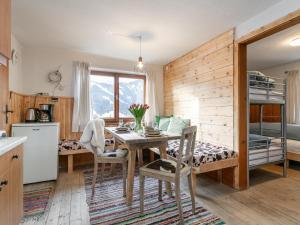a kitchen and dining room with a table and bunk beds at Sonnenhütte in Niederau +31 photos