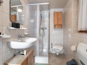 a bathroom with a sink and a shower at Sonnenhütte in Niederau