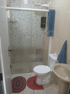 a bathroom with a shower with a toilet and a sink at Sinta se em casa in União da Vitória