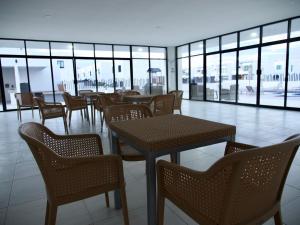 a restaurant with tables and chairs and windows at Casa Diego in La Paz