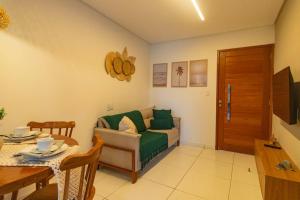 a living room with a couch and a table at Japaraty Flats in Japaratinga