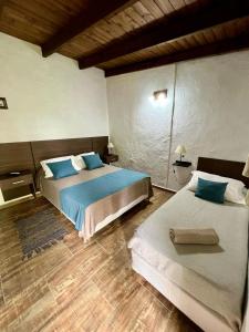 Ένα ή περισσότερα κρεβάτια σε δωμάτιο στο La Omi Hotel