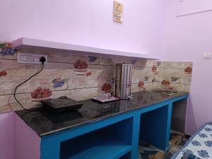 a kitchen with a counter with a sink with fruit on it at Shanti Rental And Dormitory in Kāthgodām