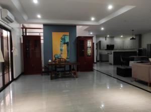 a living room with a table and a kitchen at Freya Meow Villa in Lourdes