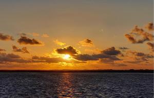 a sunset over a body of water at Lovely Apartment In Graal-Müritz in Graal-Müritz +6 photos