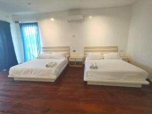 Postel nebo postele na pokoji v ubytování Sunsurf Resort Juara