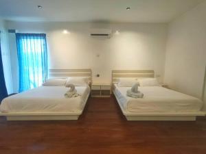 Postel nebo postele na pokoji v ubytování Sunsurf Resort Juara
