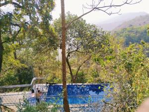a view of the mountains from the top of the hill at Sunset Valley Kerala Pool Resort - Monsoon Forest Cottage Stay in Idukki with Private Waterfalls, Natural Streams & Breathtaking Views in Pīrmed