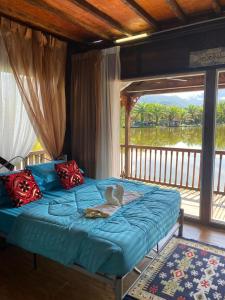 a bed with a stuffed animal sitting on top of it at Belibis Yard in Kampar