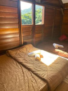 a large bed in a room with a window at Belibis Yard in Kampar