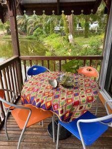 a table and two chairs on a porch with a table and chairs at Belibis Yard in Kampar