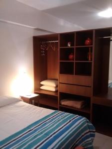 a bedroom with a bed and a book shelf at Tu Lugar en Salta in Salta