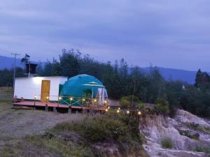 a tent sitting on top of a field at glamping casa blanca in Guatavita