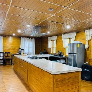 a large kitchen with a large island in the middle at Eco Cabañas El Cacao in Jutiapa