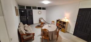 a living room with a table and a couch at Appartement Kréol Flat in Basse-Terre