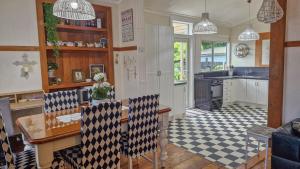 a kitchen with a table and chairs in a room at Cheerful 3 bedroom villa in Gisborne
