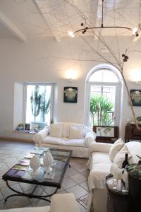 a living room with two couches and a table at B&B Casa Ruffino in Balestrate