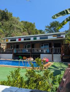 a pool at a resort with people swimming at Hangover Chill & Hill Hostel in Phi Phi Don