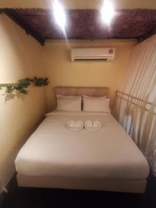 a bed in a room with two hearts on it at MacGem Heritage House at Georgetown Penang in George Town +7 photos
