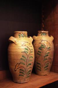 three vases sitting on a wooden table at B&B Casa Ruffino in Balestrate