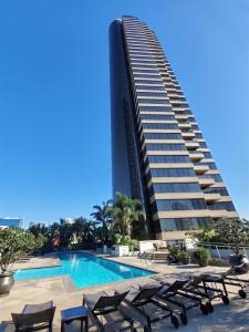 a hotel with a swimming pool and a tall building at Luxurious and Spacious 2-Bedroom Condo Unit Downtown San Diego in the Heart of the Gaslamp Quarter - 30-Day Min in San Diego