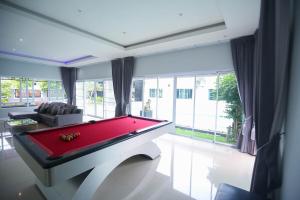 a living room with a red pool table in it at Pool Villa near Chiang Mai city with WiFi in Saraphi