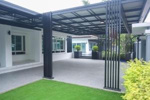 a pergola over a patio of a house at Pool Villa near Chiang Mai city with WiFi in Saraphi