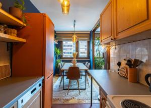 a kitchen with a table and a dining room at Heart of the City - Free Parking in Pristina