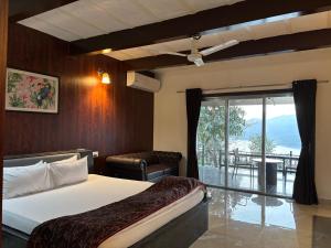 浦那The Green Gate Resort Mulshi的一间卧室，里面有一张床、一把椅子和一扇窗户
