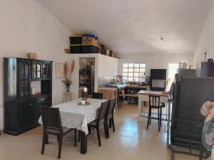 a dining room with a table and chairs in a kitchen at Rancho de Solis in Arteaga