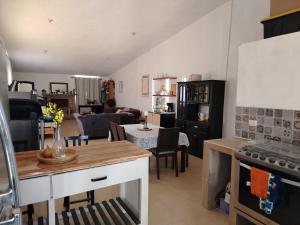 a kitchen and living room with a couch and a table at Rancho de Solis in Arteaga