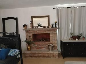 a living room with a brick fireplace with a mirror at Rancho de Solis in Arteaga