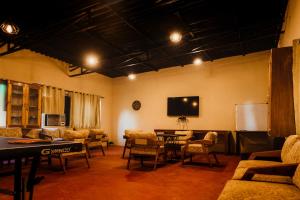 a living room with a table and chairs and a tv at Greetoe Camp Panna in Khajurāho