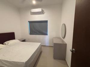 a bedroom with a bed and a mirror and a sink at Canterbury Golf Apartment in Gonapola