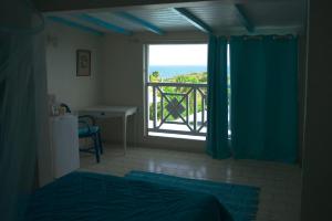 A bed or beds in a room at Hotel Cap Sud Caraibes