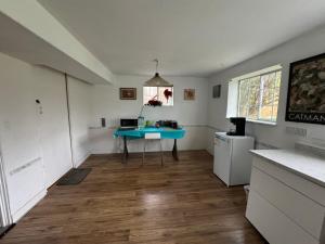 a kitchen with a blue table in a room at Surrey central house in Surrey