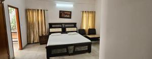 a bedroom with a bed and a chair and a window at Prashanth kuteer in Hyderabad