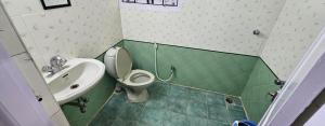 a small bathroom with a toilet and a sink at Prashanth kuteer in Hyderabad
