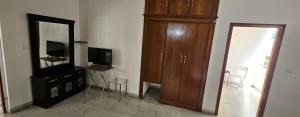 a living room with a large wooden cabinet and a mirror at Prashanth kuteer in Hyderabad